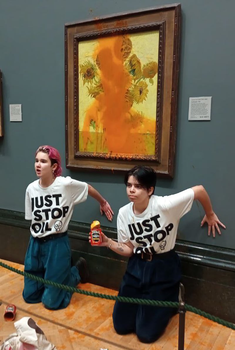 Two protesters threw tinned soup at Vincent Van Gogh’s famous 1888 work Sunflowers at the National Gallery