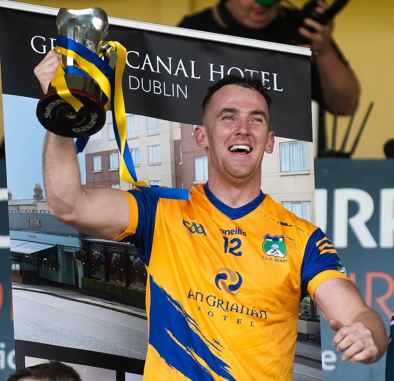 Burt captain Ronan McDermott lifts the Corn Mumhan after Saturday’s final. Photo Evan Logan