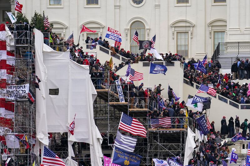 Demonstrators loyal to Donald Trump riot outside the Capitol in Washington in January 2021 (John Minchillo/AP)