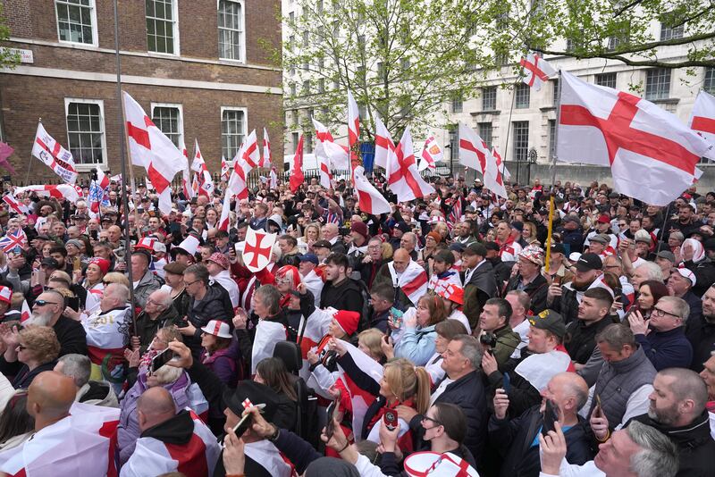 People wave flags during a St George’s Day rally on Whitehall