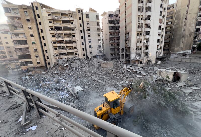 A worker uses a bulldozer to remove the rubble of a destroyed building that was hit in an Israeli airstrike on Dahiyeh (Hussein Malla/AP)