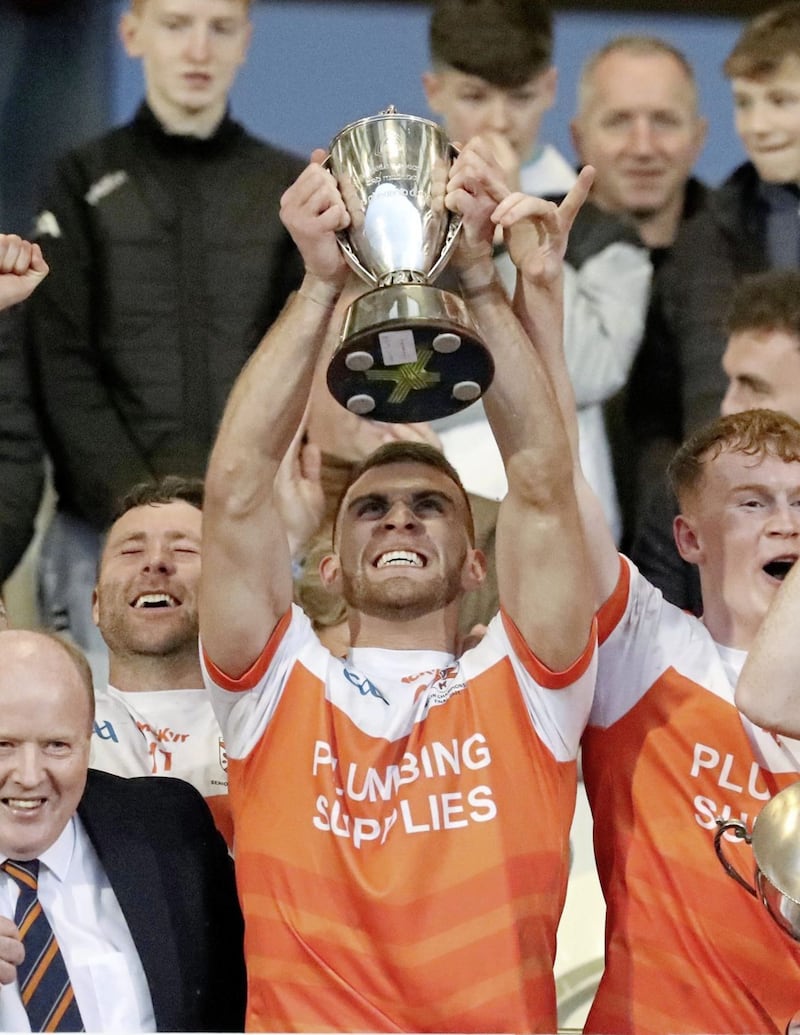 Clann Eireann captain Shea Heffron raises the Gerry Fagan Cup aloft in delight. Pic Philip Walsh 