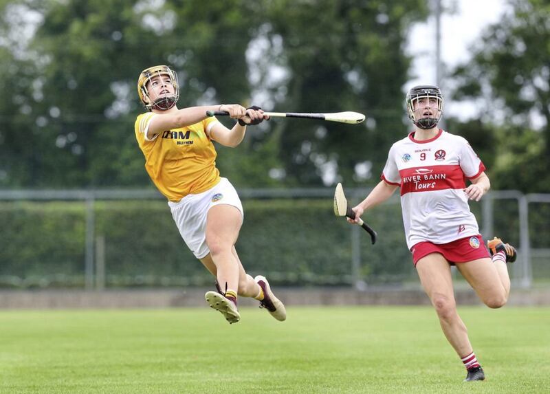 Antrim Maeve Kelly fires a score over the bar ahead of Megan Kerr of Derry during the Ulster Senior Camogie Championship semi final played at Loughgiel on Saturday 3rd of July 2021. Picture Margaret McLaughlin 