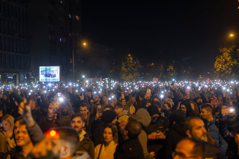 People light their mobile phones during a protest in Novi Sad, Serbia (Marko Drobnjakovic/AP)