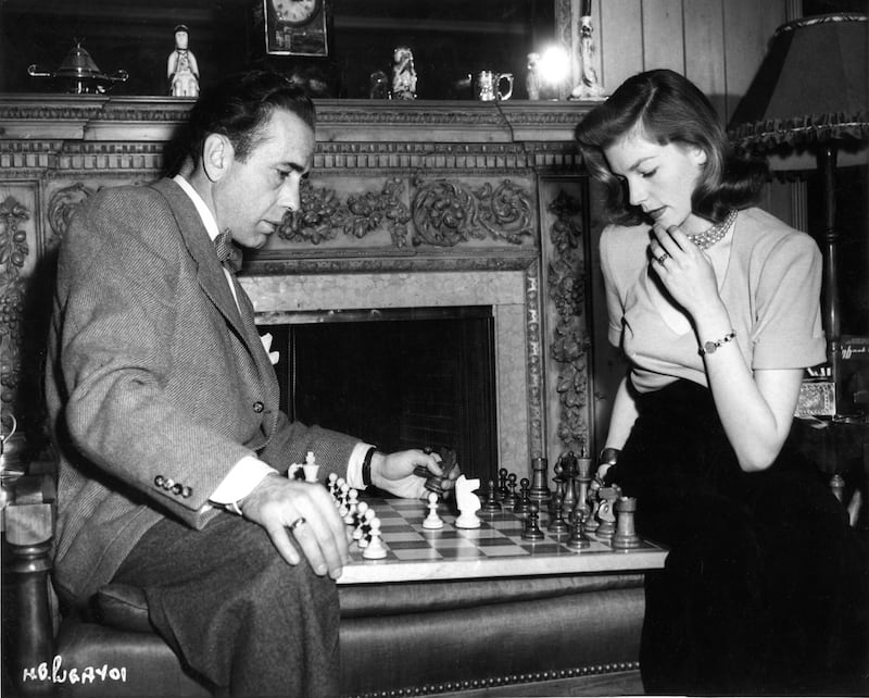 Humphrey Bogart and Lauren Bacall playing chess at their Benedict Canyon home in Los Angeles (1945)