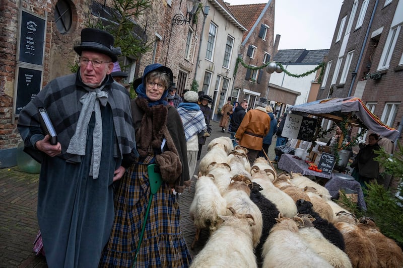 Sheep are driven through the town (Peter Dejong/AP)