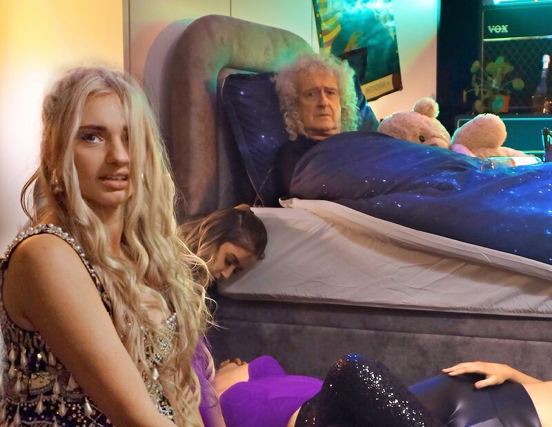 Talia Dean and Brian May star in the video