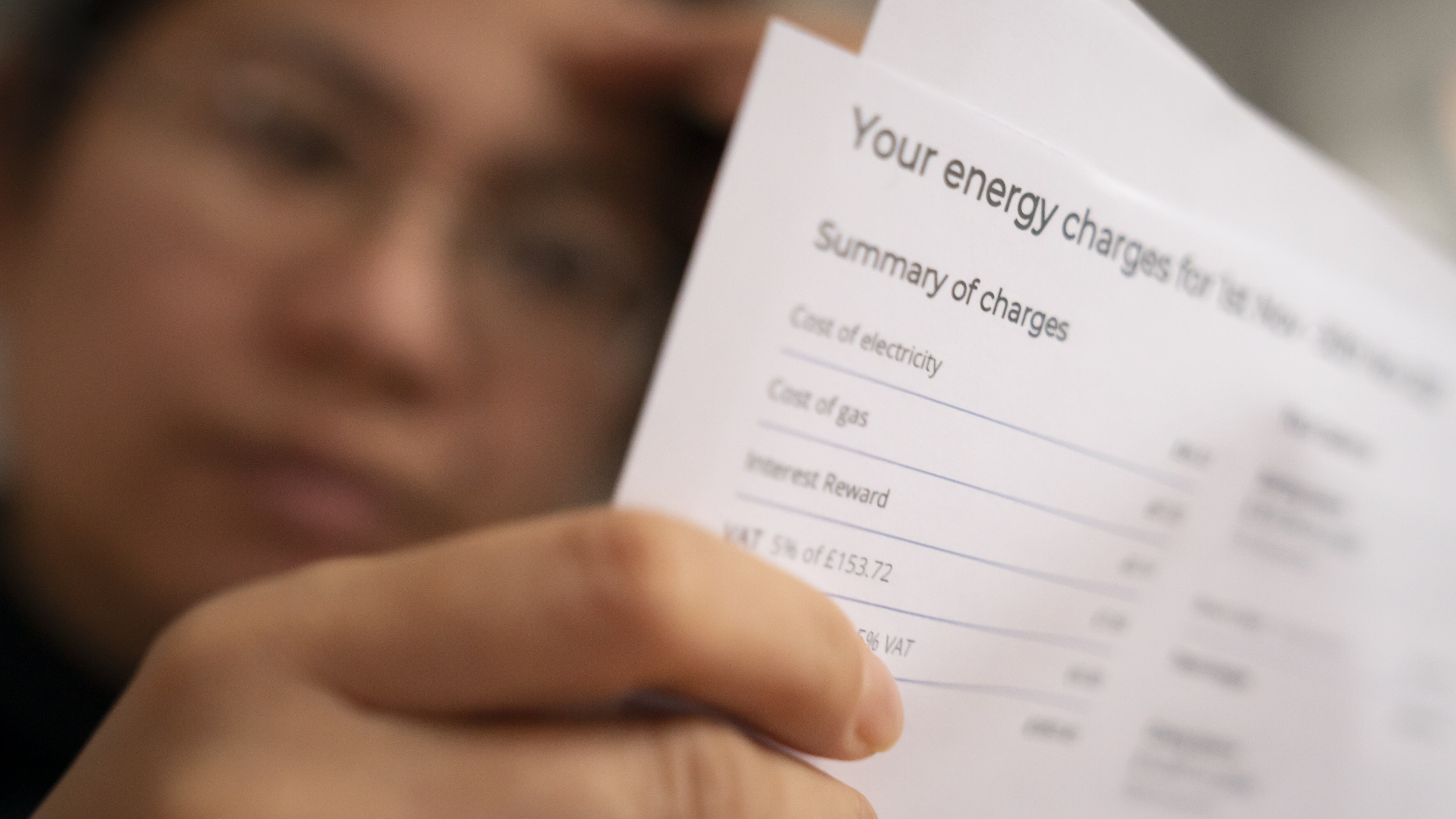 A person holding an energy bill