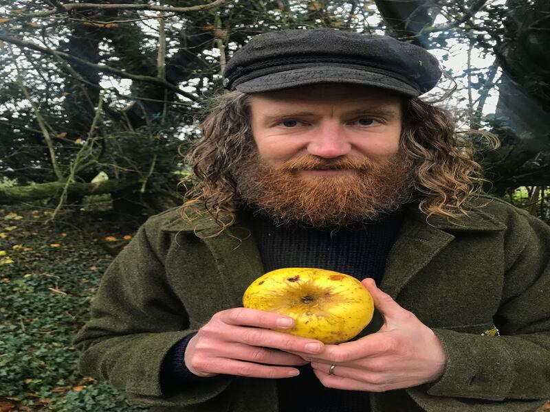 Archie Thomas holding his apple find in woodlands near his home (Hannah Thomas/PA)