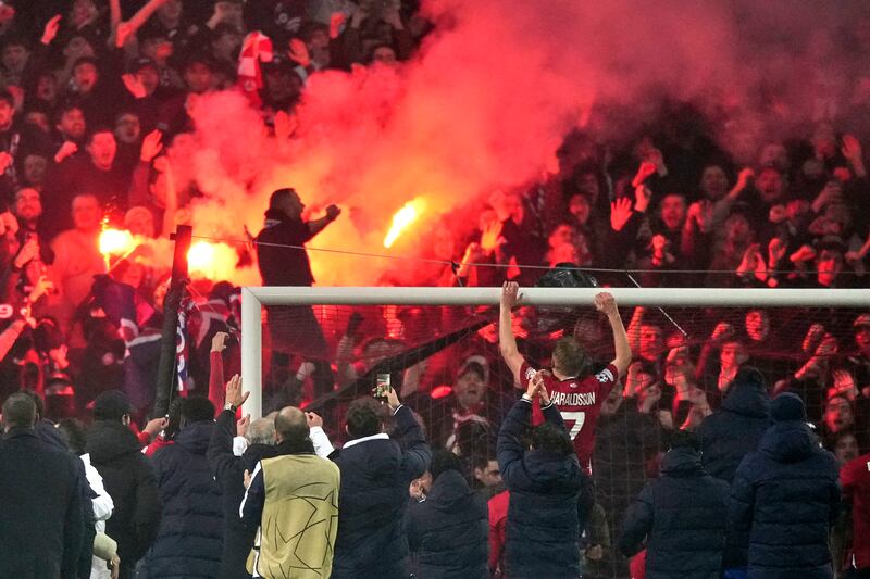 Lille’s players and fans celebrated their win in style (Michel Euler/AP)