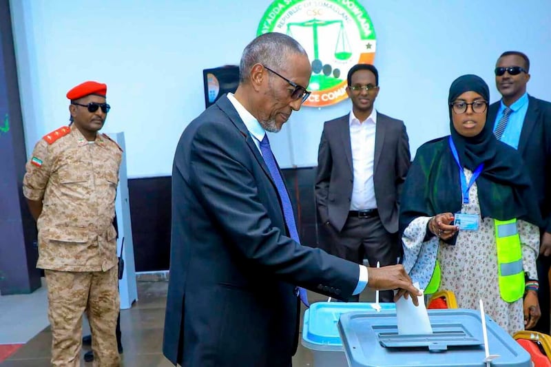 President Muse Bihi Abdi, centre, cast his vote in a polling station in Hargeisa (Abdirahman Aleeli/AP)