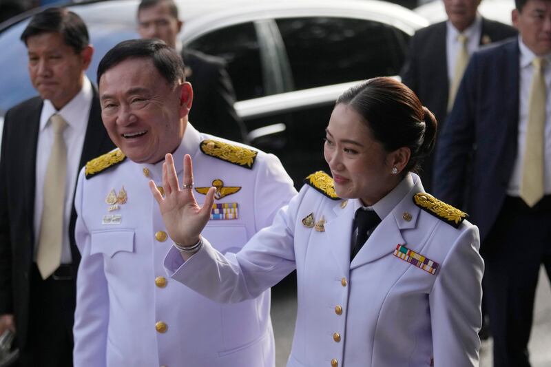 Thailand’s former Prime Minister Thaksin Shinawatra, left, and his daughter and newly elected Prime Minister Paetongtarn Shinawatra arrive at the ceremony (Sakchai Lalit/AP)