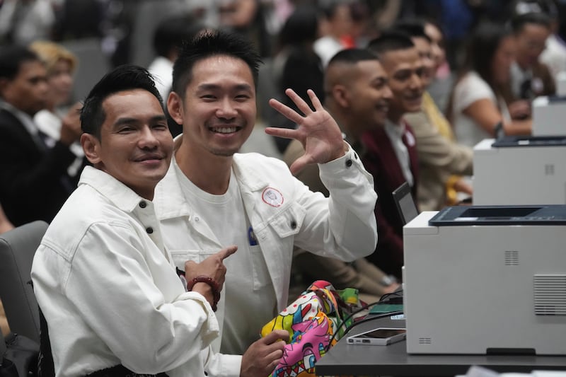 A couple from the LGBTQ+ community wait to sign their marriage certificates in Bangkok (Sakchai Lalit/AP)