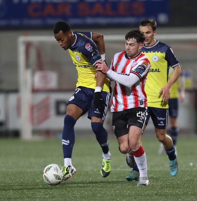 Derry City Adam O'Reilly with Rayhaan Tulloch of Shelbourne during Friday nights match at the Brandywell