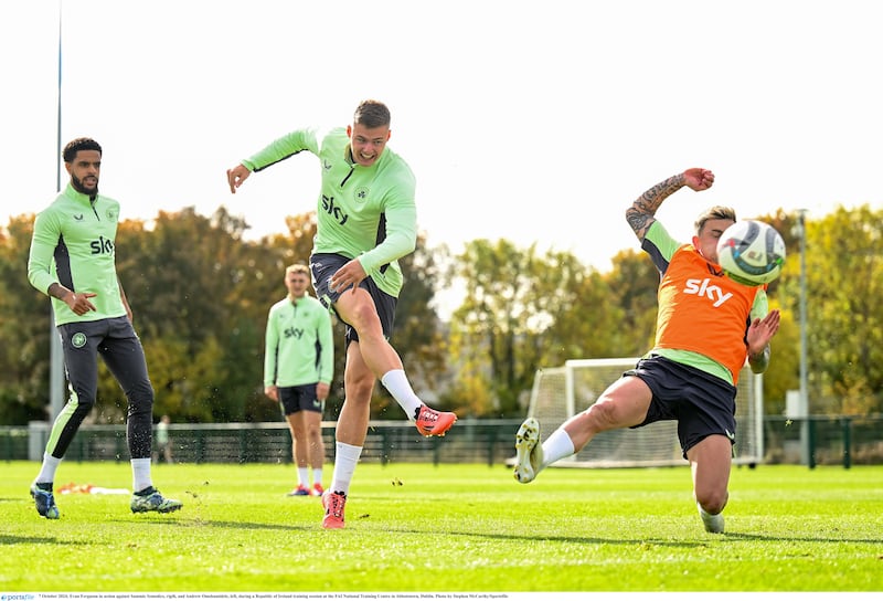 Evan Ferguson in action against Sammie Szmodics, rigth, and Andrew Omobamidele, left, during a Republic of Ireland training session at the FAI National Training Centre in Abbotstown, Dublin