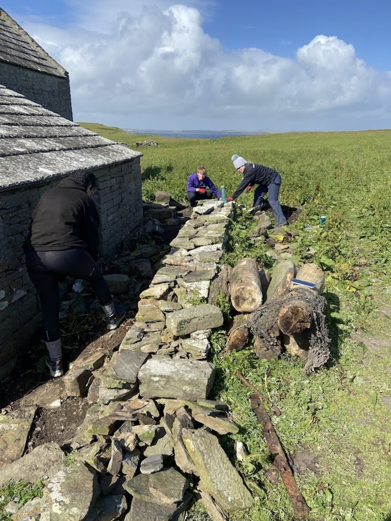 Wall rebuilding on island of Swona .